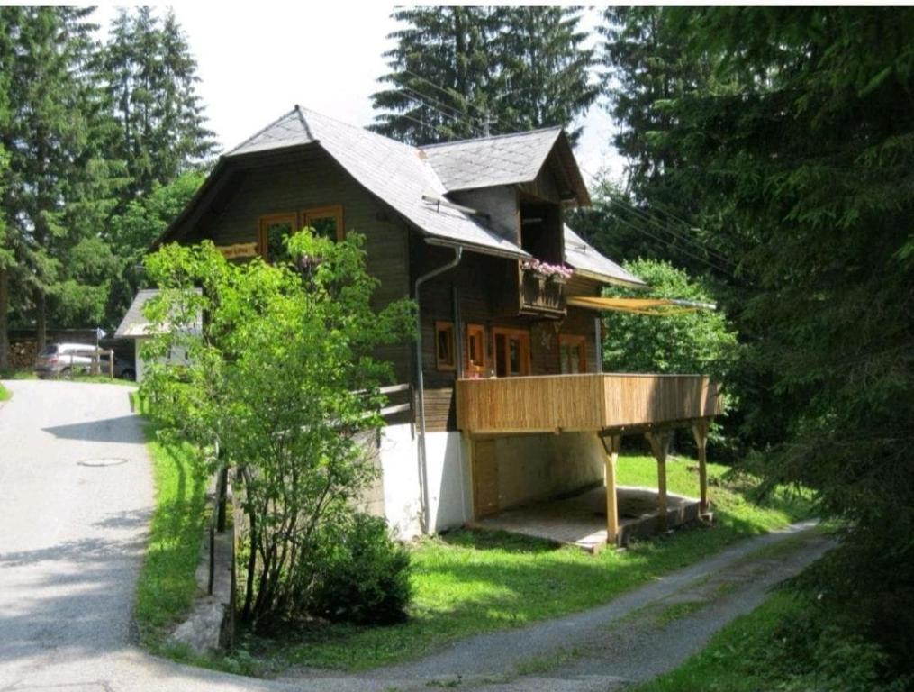a small wooden house with a porch in the yard at Lovely chalet in Alps in Bad Kleinkirchheim
