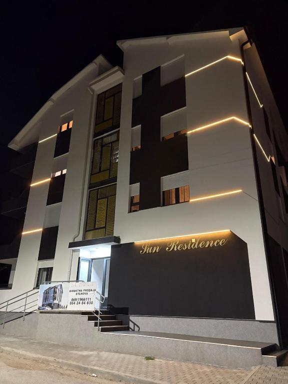a building with a sign on the side of it at Apartman Iva in Soko Banja