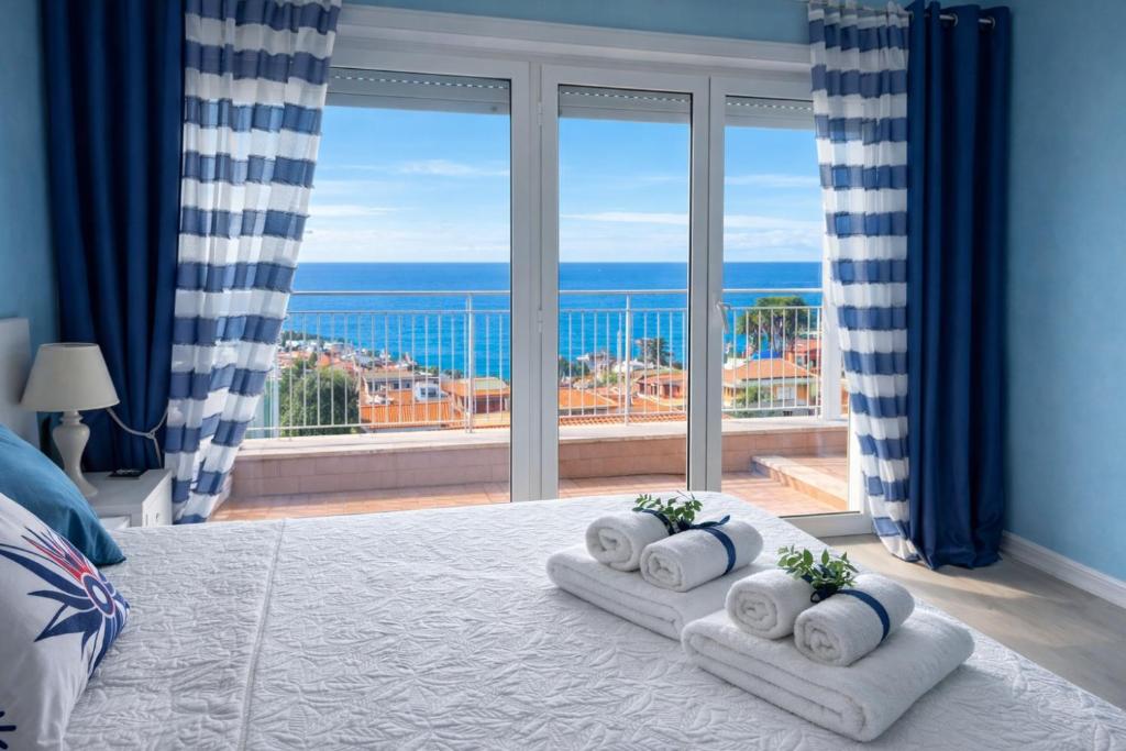 a bedroom with a view of the ocean from a bed at Due Passi dal Cielo Apartment Piscina Condominiale fino al 30 Agosto in Anzio