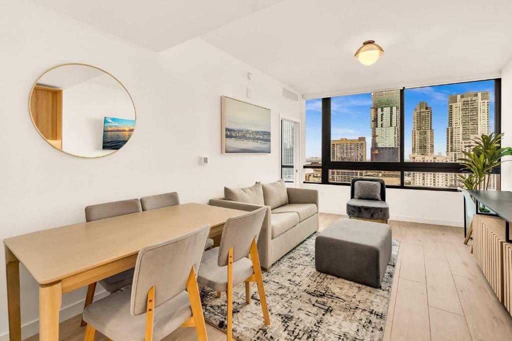 a living room with a table and a couch at Miami Oasis 2BR Apt Pool & Beach Access for 5 in Miami