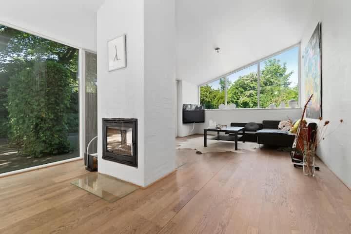 a living room with a fireplace and a couch at Spacious Luxury Villa Apartment - Two Bedrooms in Egå
