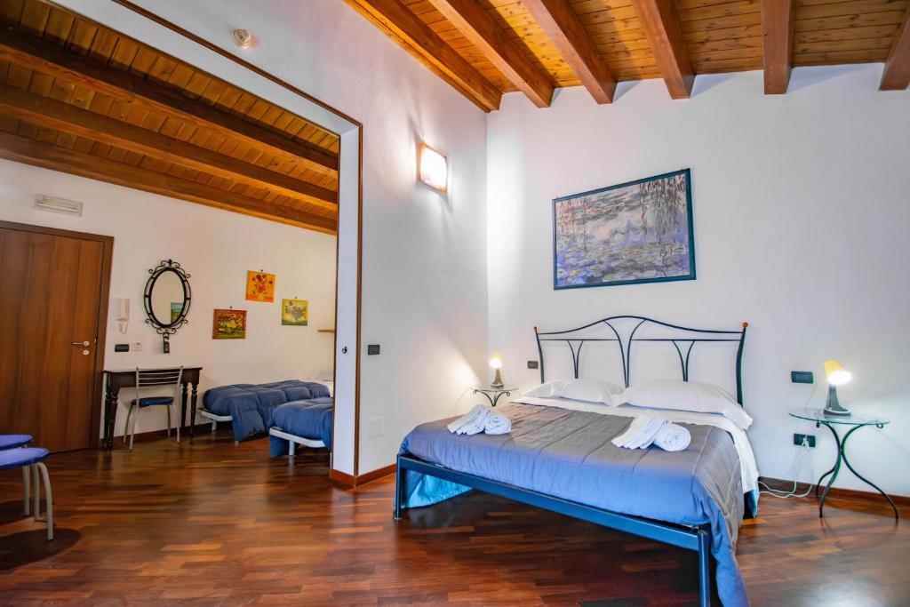a bedroom with a bed and a desk in a room at Case Ruggero in Cefalù