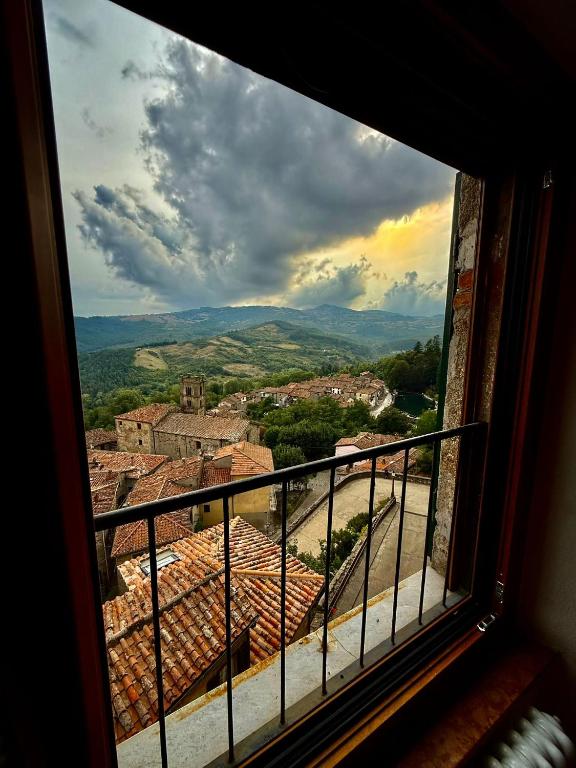 a view of a city from a window at CASA LALLINO - Tuscan ToBe srl in Santa Fiora
