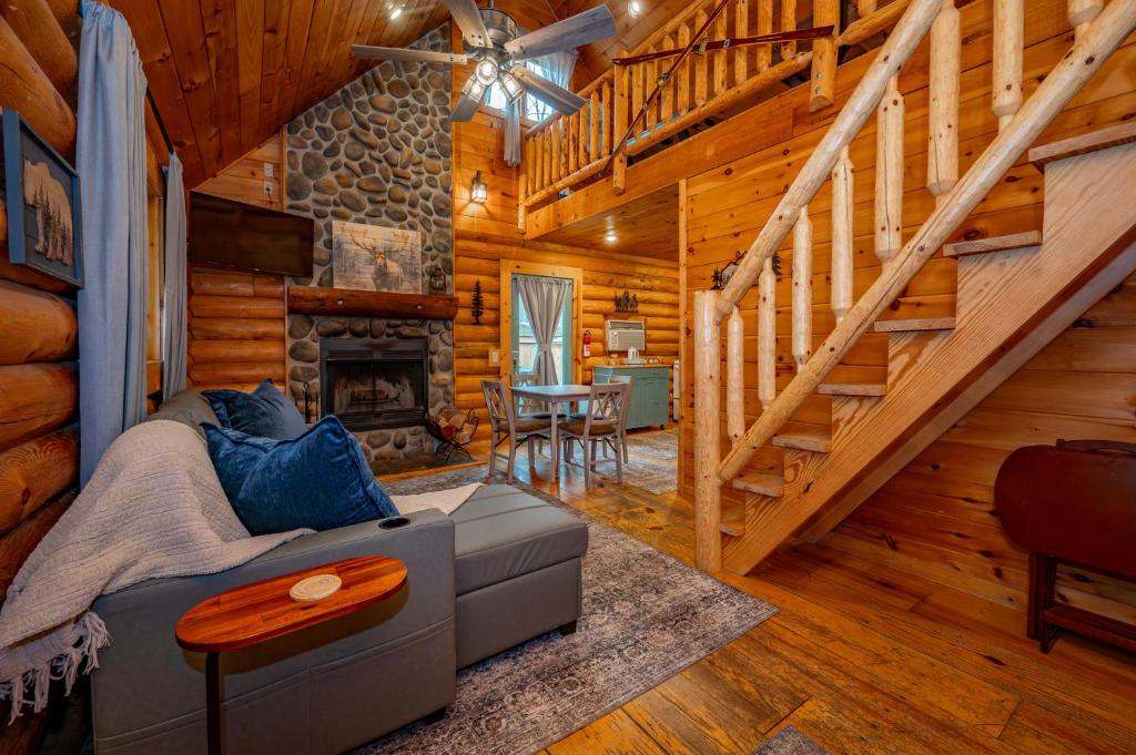 a living room with a fireplace in a log cabin at Johnsons Creek Cabin by Railey Vacations in Oakland