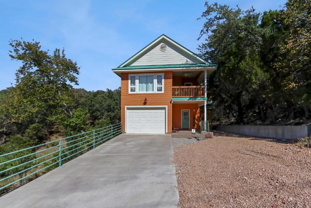 a orange house with a white garage at Green Roof Cottage in Canyon Lake