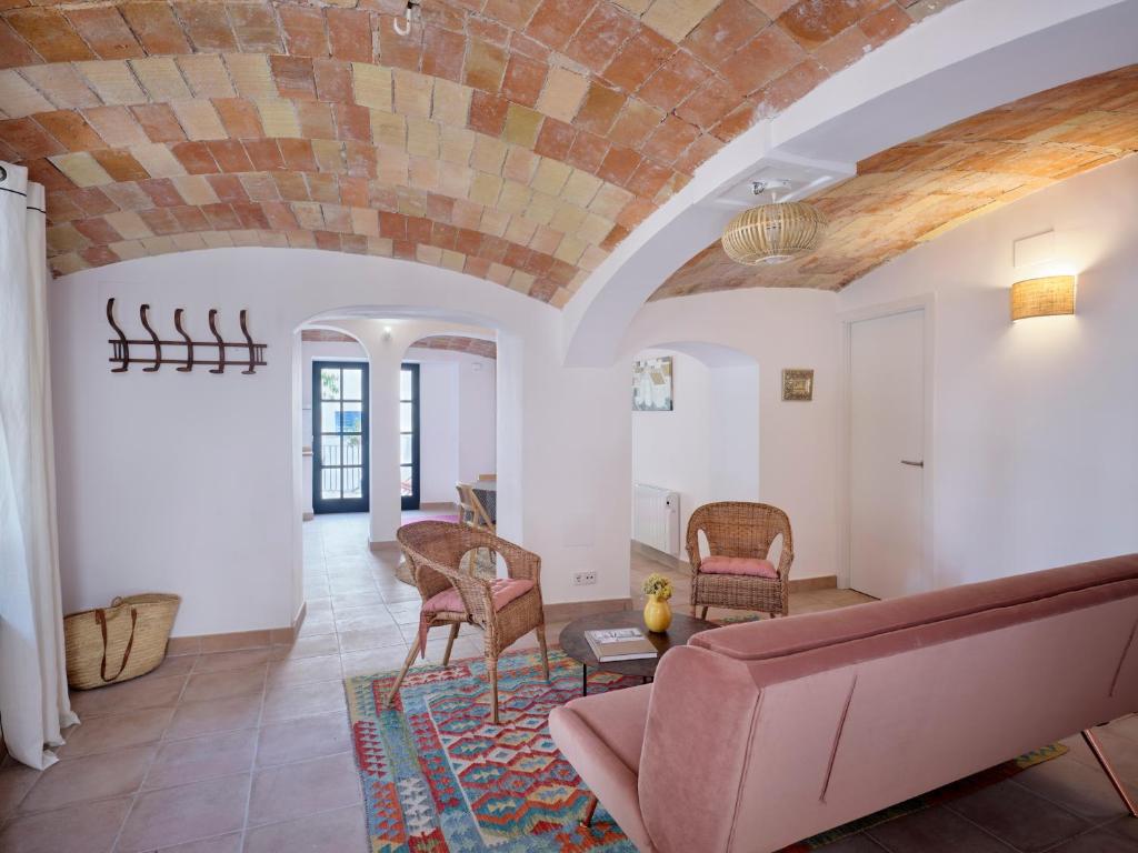 a living room with a brick ceiling and a couch at Apartment at Cadaqués Church in Cadaqués
