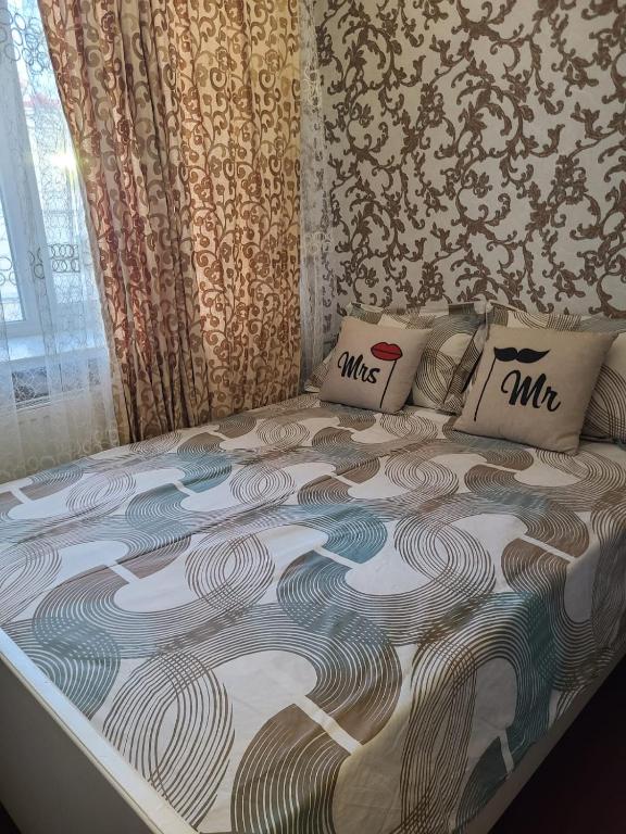 a bed with two pillows on it in a room at Апартаменти в Центі Одеси in Odesa