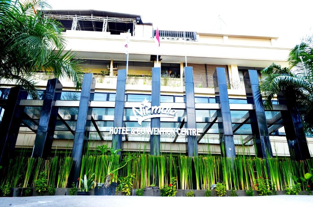 a building with a sign on the front of it at Nirmala Hotel & Convention Centre in Denpasar