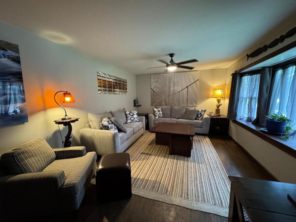 a living room with a couch and a table at Super Comfy 3 BR Home Sleeps 8 in Doraville