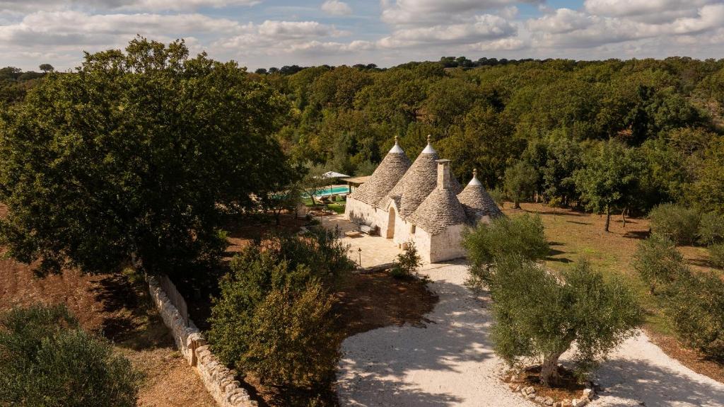 an aerial view of a house in a field with trees at Trullo Elisa in Monopoli