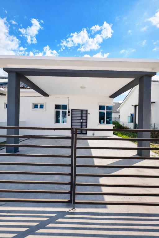 a white house with stairs in front of it at The Luxe Permata by Haffa in Lunas