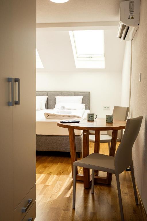 a small room with a table and a bed at Sarajevo Boutique Studios in Sarajevo