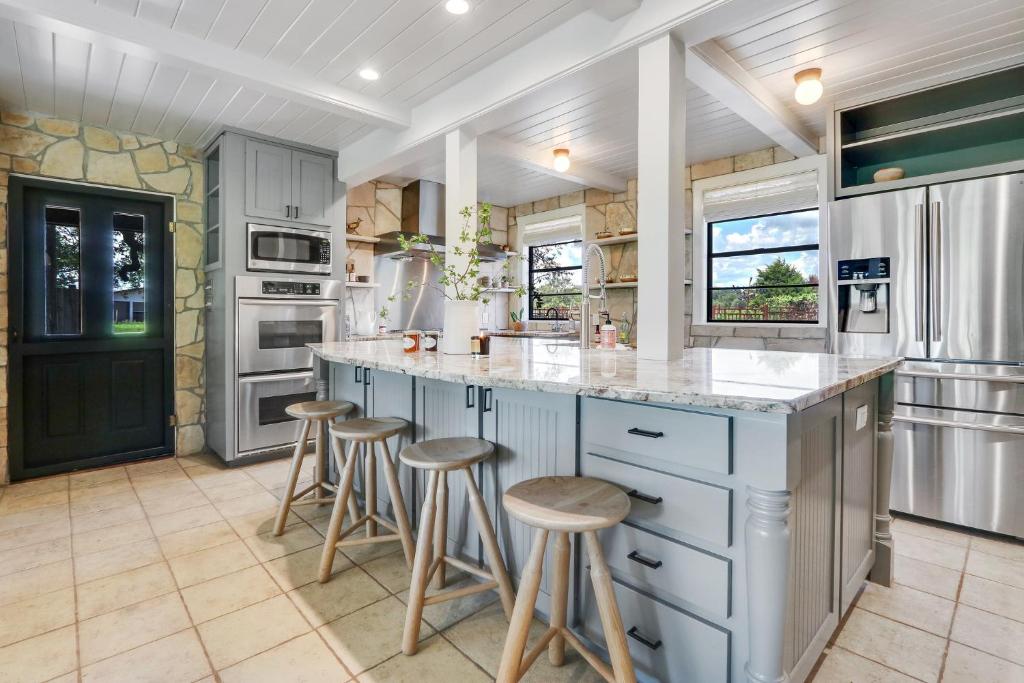 a kitchen with a counter and stools in it at D2 Farms Main House in Wimberley