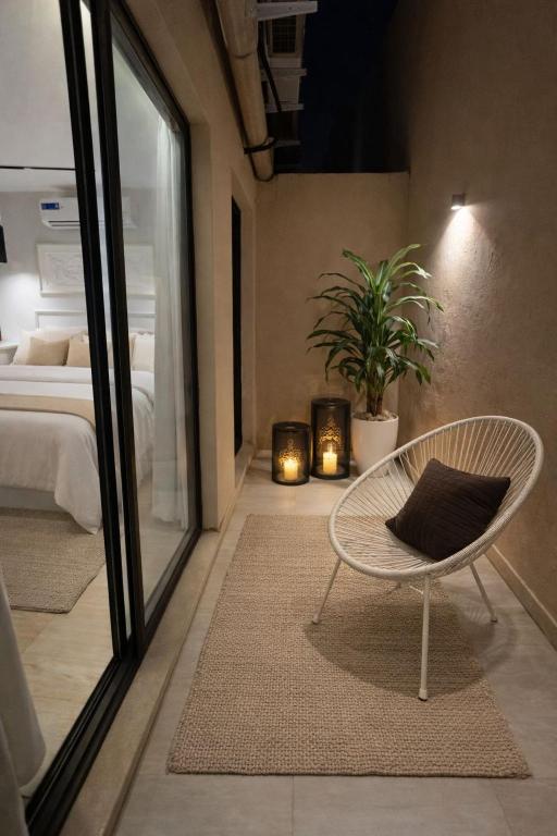a bedroom with a bed and a chair with a pillow at Modern Studio Near Al Haram And City Center Self Check-in in Medina