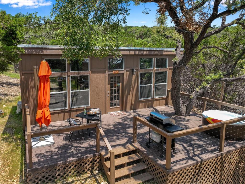 a tiny house on a deck with a tree at Martha at the Bend in Wimberley