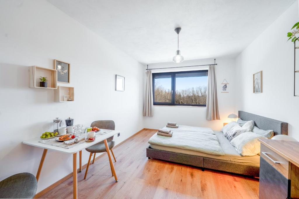 a living room with a bed and a table at Studio Arnoštka in Vimperk
