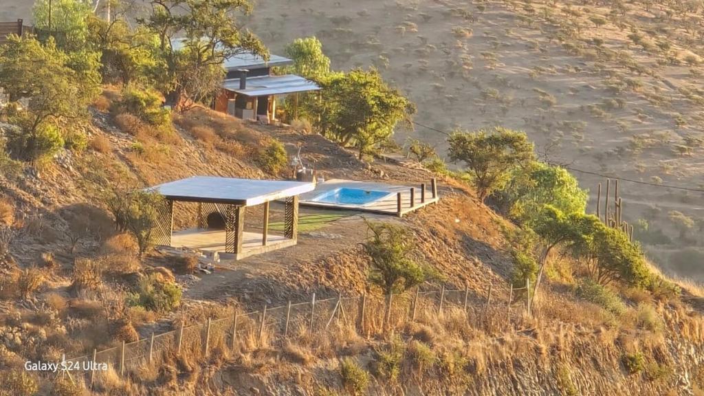 a house on top of a hill with a swimming pool at Romantic Getaway Peace and a Unique View in Quillota