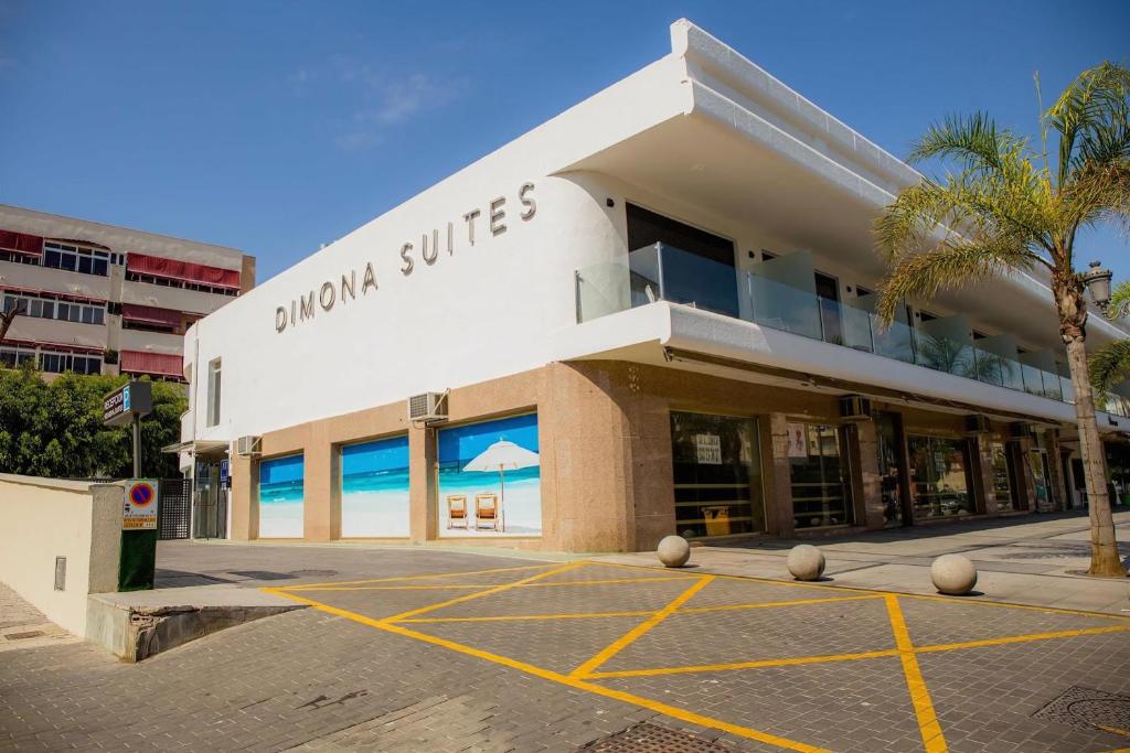 a building with a parking lot in front of it at BLUESEA Dimona Suites in Torremolinos