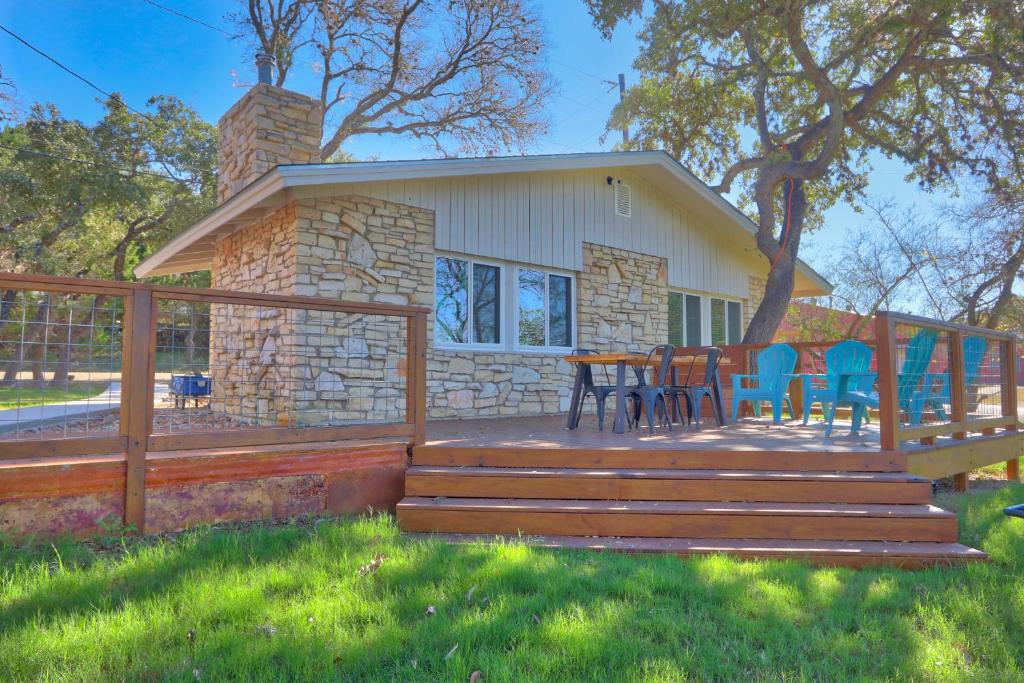 a wooden deck with chairs and a table on it at Millies Cottages Unit 1 - Ruth in Canyon Lake