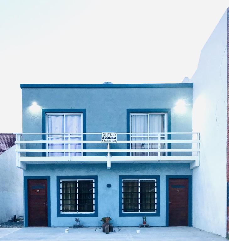 a blue building with a balcony and a street sign at Complejo del Mar in Santa Clara del Mar