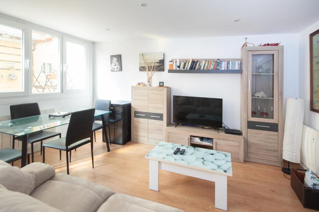 a living room with a couch and a table at AG Piso Fogar Carballo, 3 habitaciones in Carballo