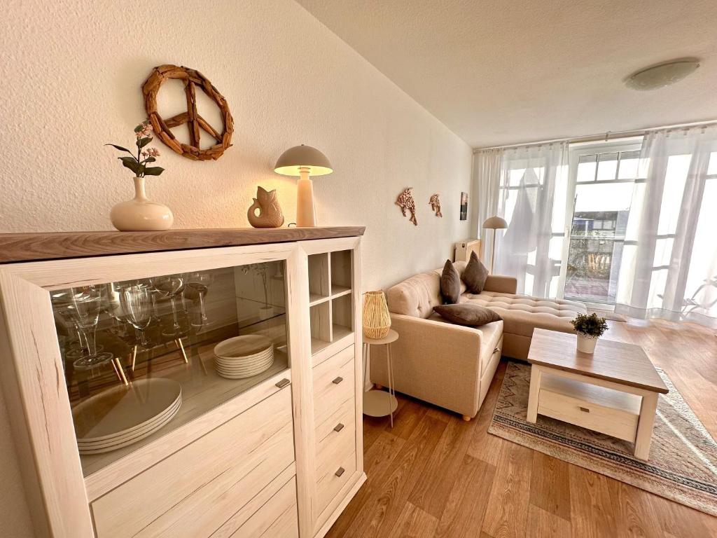 a living room with a large cabinet with a fish tank at Ferienwohnung De Diek 103 in Dorum-Neufeld