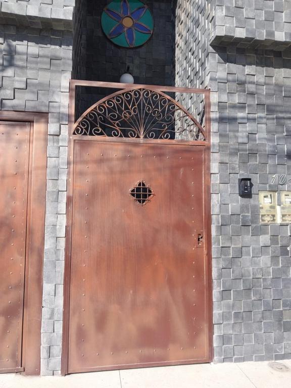 a large wooden door on a brick building at Bem Estar no Bom Ap 2 in Arapiraca