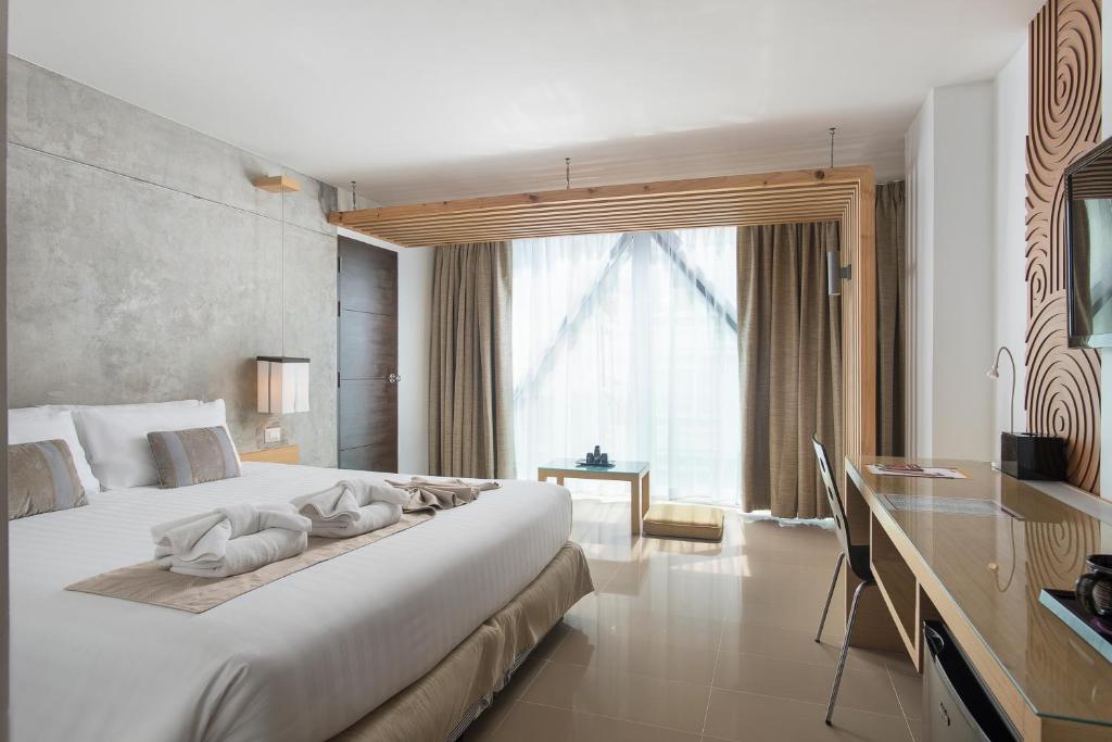 Postel nebo postele na pokoji v ubytování Nimman Mai Design Hotel Chiang Mai