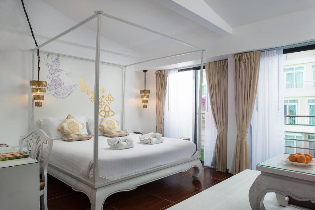 Postel nebo postele na pokoji v ubytování Nimman Mai Design Hotel Chiang Mai
