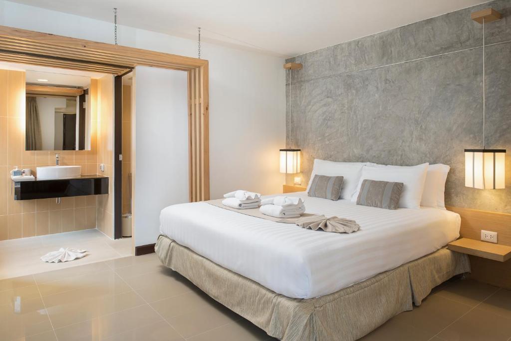 Postel nebo postele na pokoji v ubytování Nimman Mai Design Hotel Chiang Mai