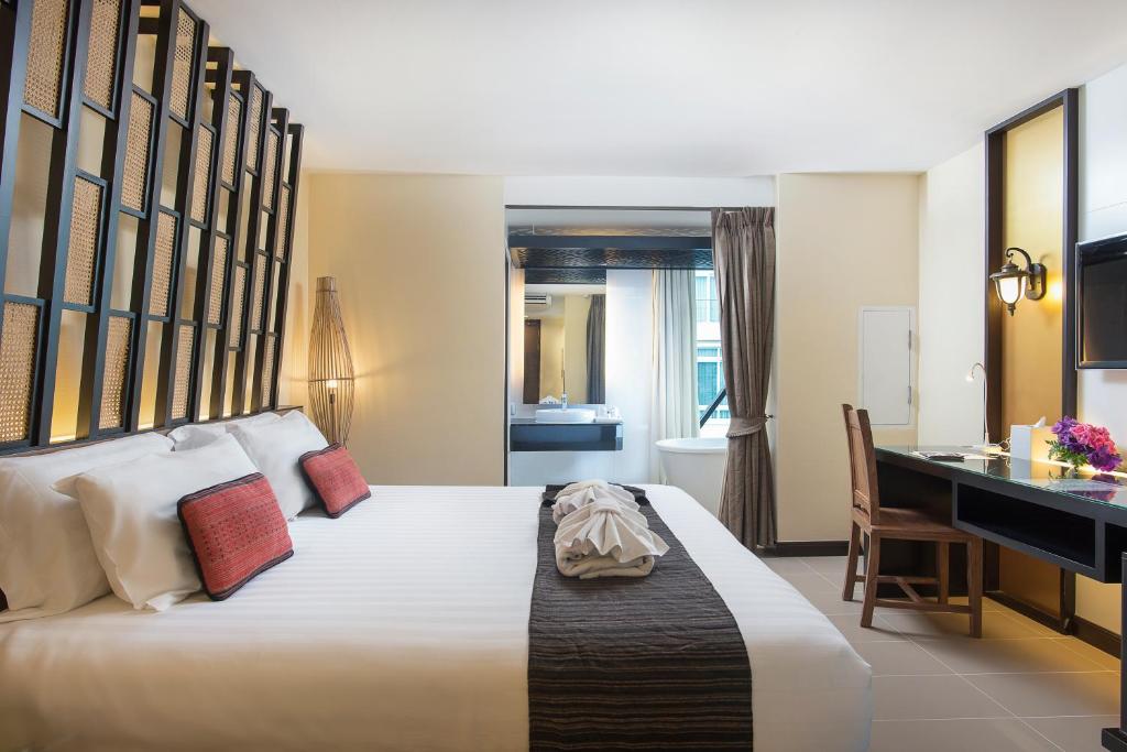 Postel nebo postele na pokoji v ubytování Nimman Mai Design Hotel Chiang Mai