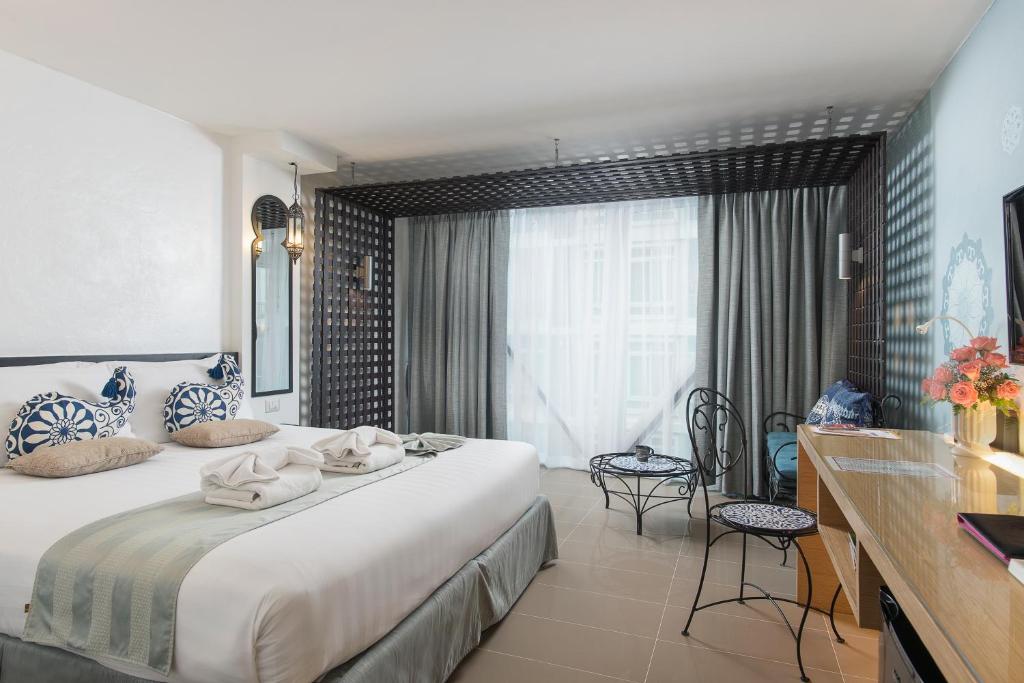 Postel nebo postele na pokoji v ubytování Nimman Mai Design Hotel Chiang Mai
