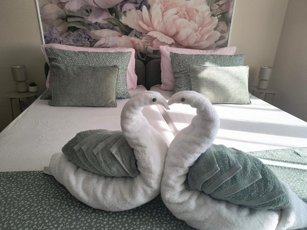 two swans sitting on top of a bed at Apartmani Marijana in Lozovac