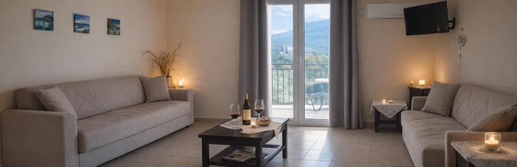 a living room with two couches and a table at Rodanthy I in Katelios
