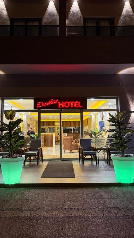 a store front of a hotel with tables and chairs at Dostlar Hotel in Mersin