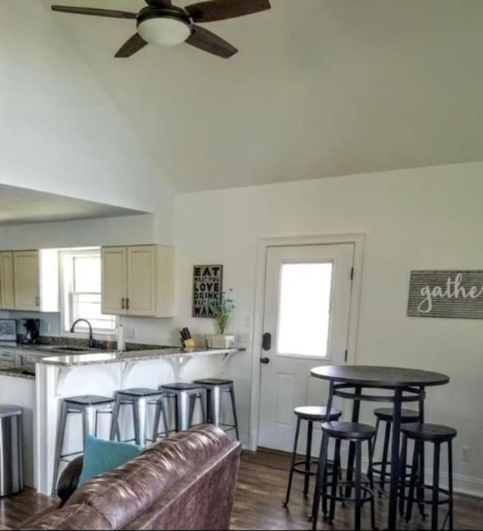 a living room with a couch and a table at Potter Cottage - Beautiful Serene Setting in Ferdinand