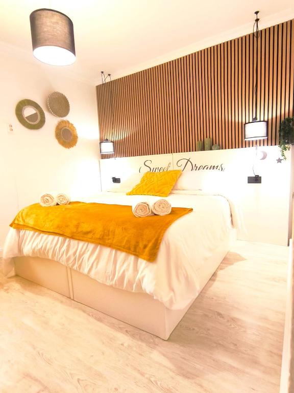a bedroom with a large bed with two pillows on it at Apartamento Lances playa tarifa in Tarifa