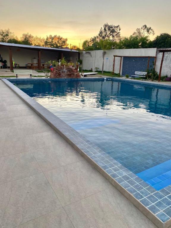 a large swimming pool with blue water at Chácara Jacinto Alves in Paulo Afonso