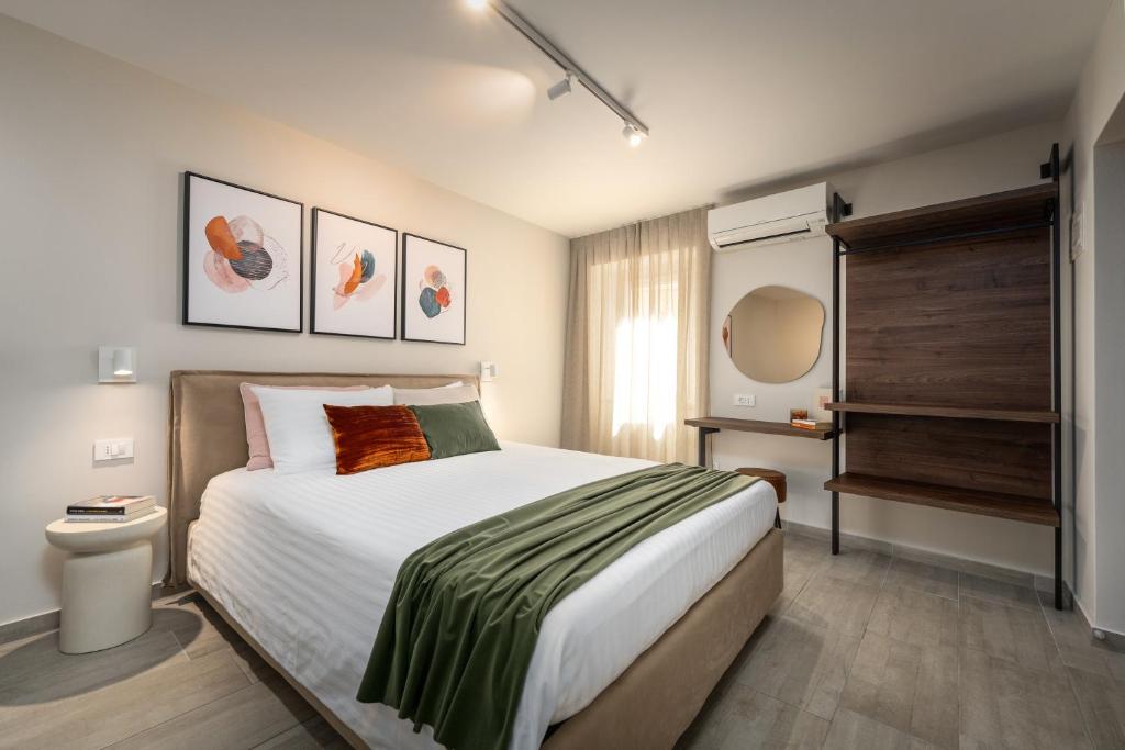 a bedroom with a large bed and a window at Degrassi Square Apartments in Vrsar
