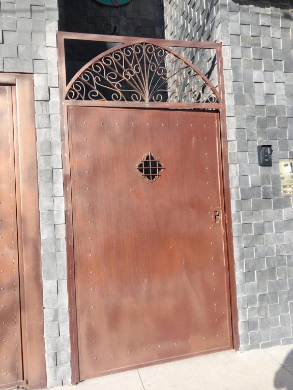 a large wooden door with a metal gate at Bem Estar no Bom Ap 1 in Arapiraca