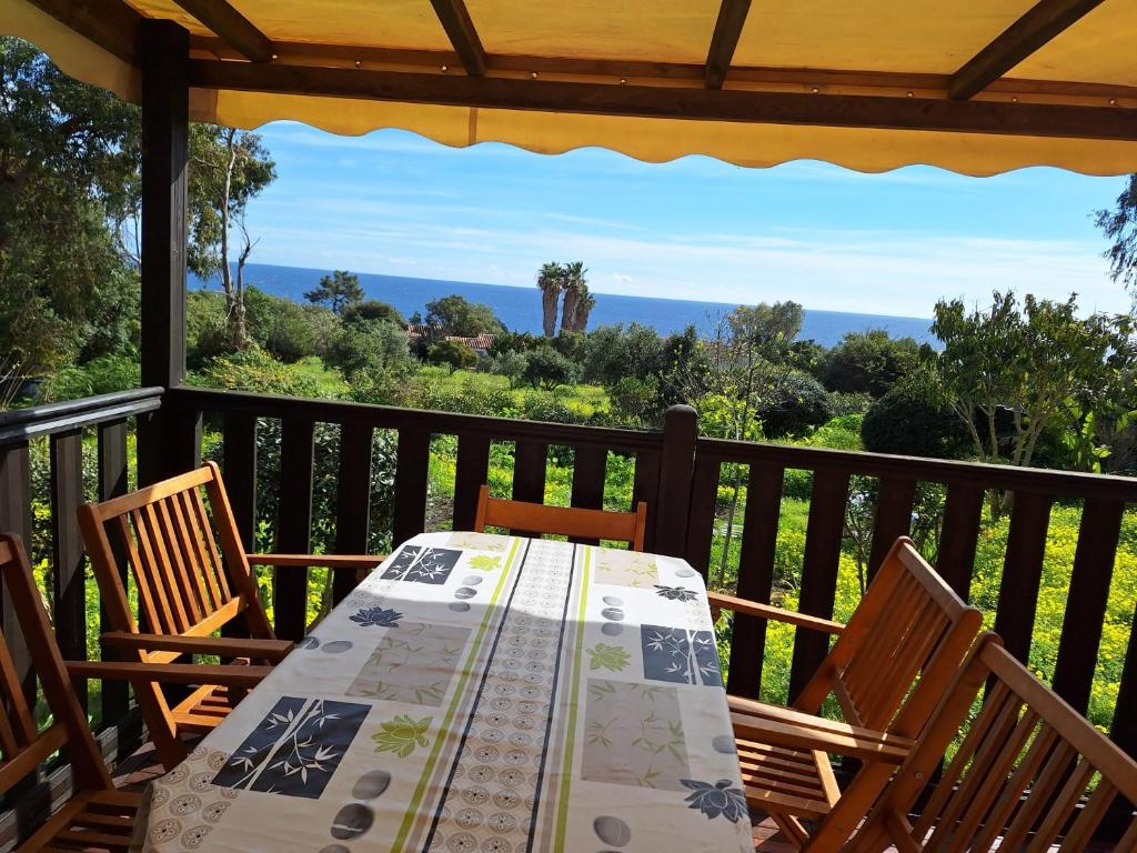 a table and two chairs on a porch with a view at Chalet Horizon Mer in Conca