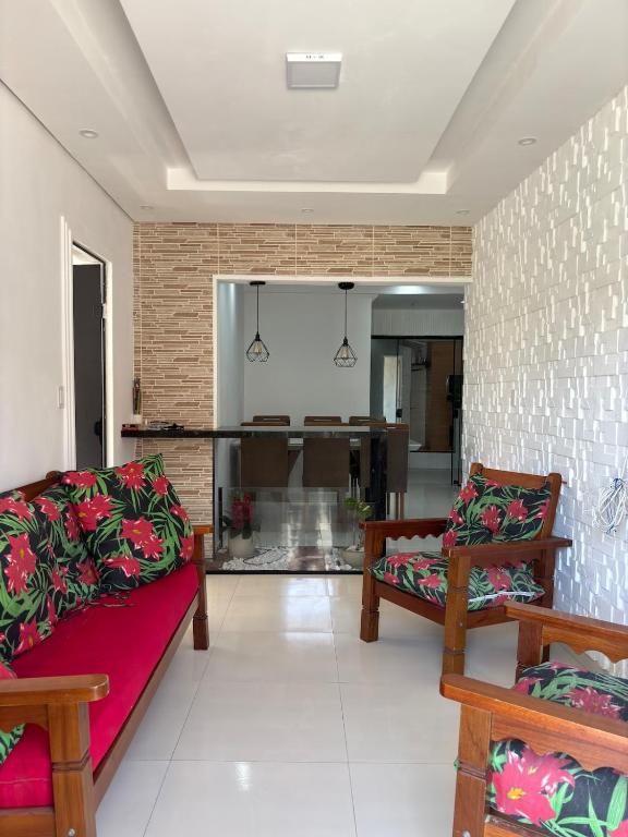 a living room with two couches and a brick wall at Casa Aurora Provetá - Ilha Grande in Angra dos Reis