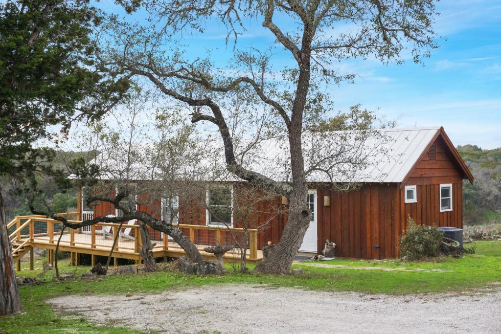a barn with a deck and a house at Burnett Ranch Cabins- Prickly Pear in Wimberley