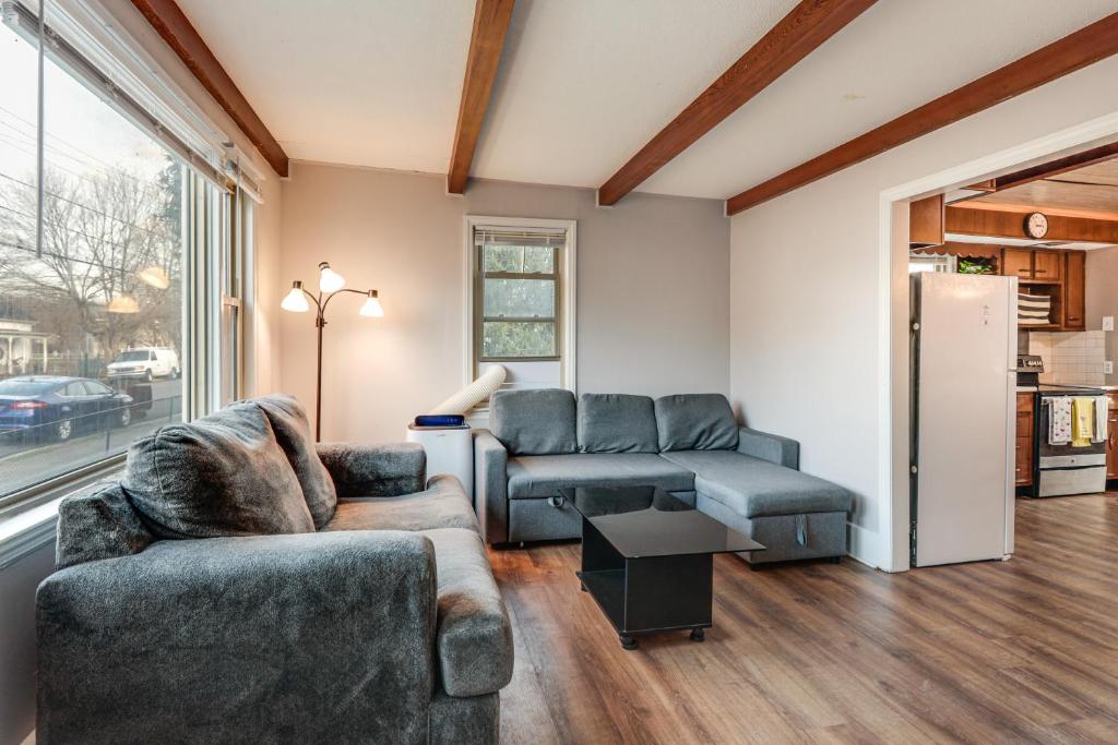a living room with two couches and a refrigerator at Warren County Launchpad: Pet-Friendly Lebanon Apt in South Lebanon