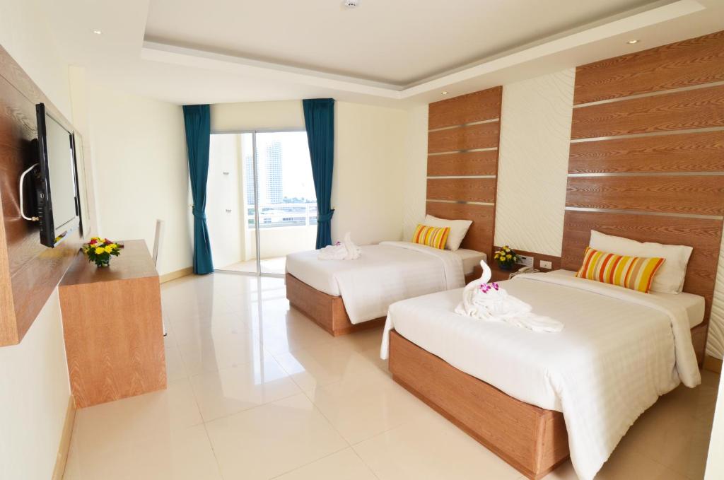 Postel nebo postele na pokoji v ubytování Welcome Jomtien Beach Hotel