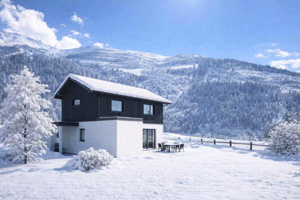 a black and white house in the snow at Chalet Villa Hera in Bichlbach