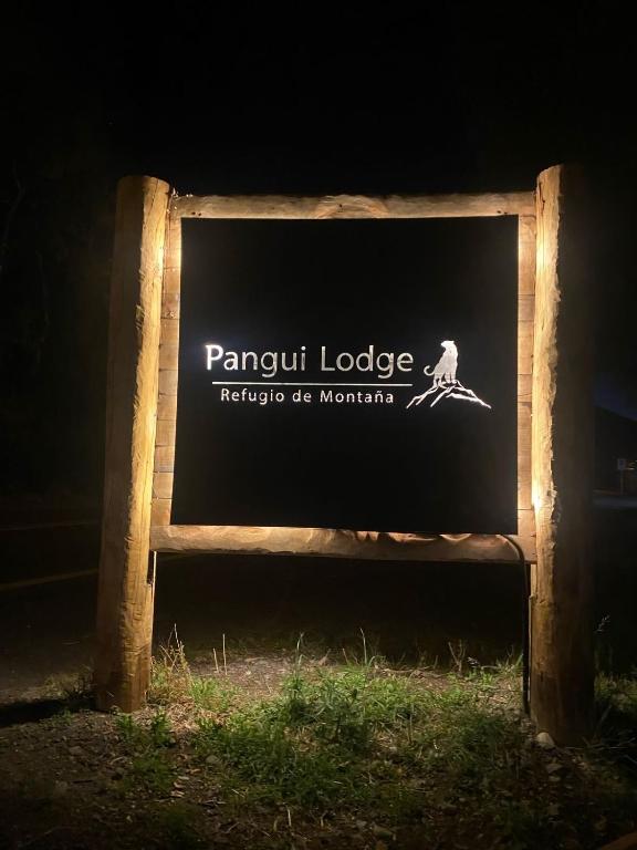 a sign for a pamput lodge in the dark at Pangui Lodge in Las Trancas