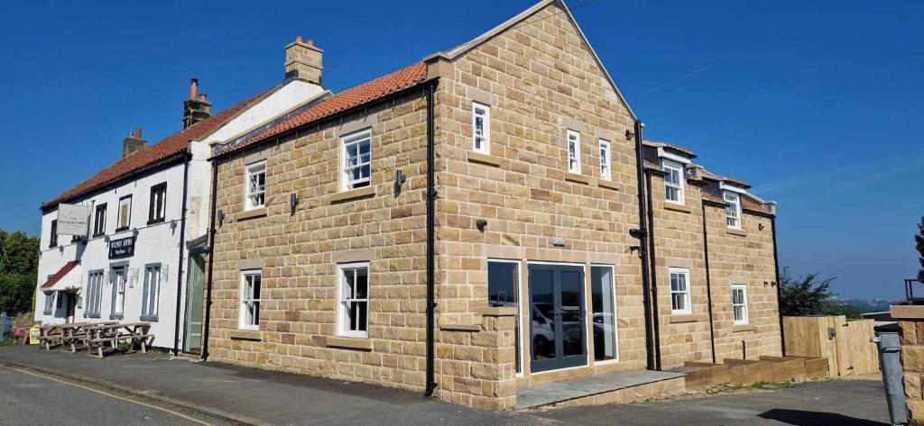 a large brick building on the side of a street at The Wilson Arms in Sneaton