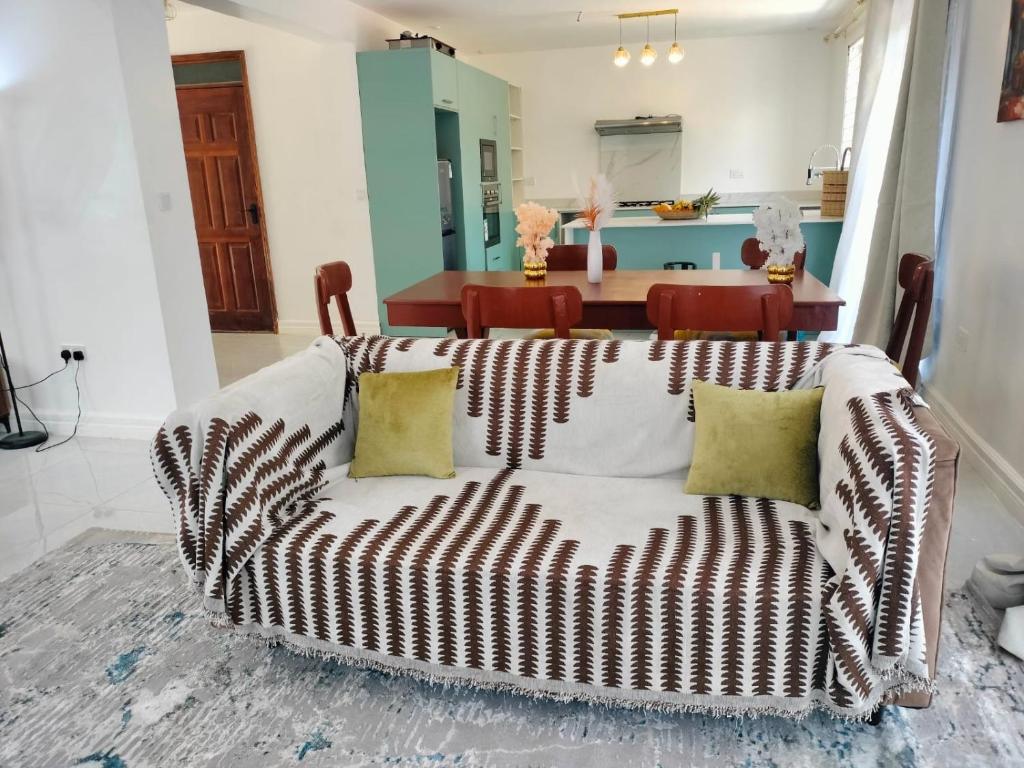a living room with a couch and a table at Prime Elgon View 5BR Family Home Private Secure in Eldoret