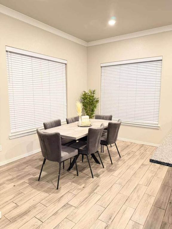 a dining room with a table and chairs at The West House Cozy-Modern-Spacious in Midland